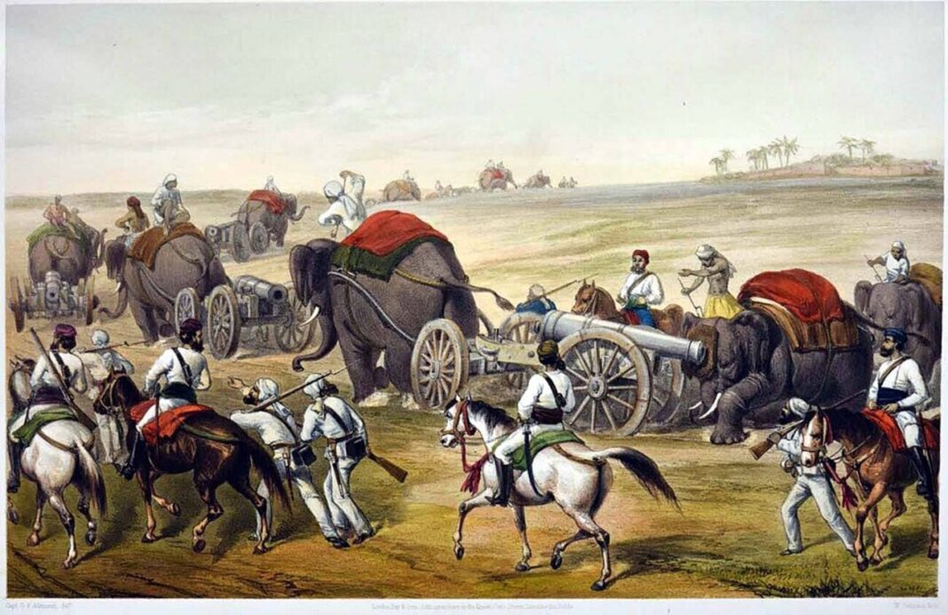 Ilustracja przedstawiająca powstanie sipajów w Indiach – armia z działami ciągniętymi przez słonie i żołnierzami na koniach